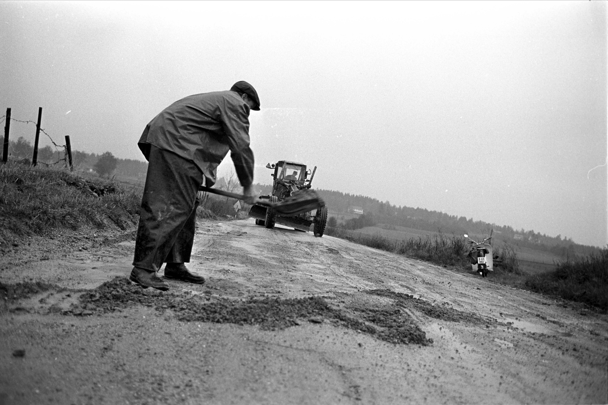 Riksvei 1 fra Svinesund, mai 1963. Mann med spade, veiskrape.
