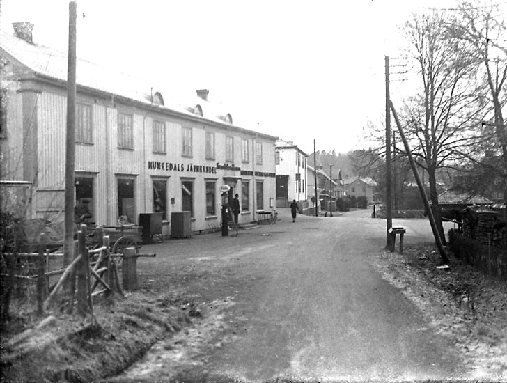 Enligt noteringar: "Hanssons affärsfastighet vid järnvägsstationen. Affärshuset mot vägen byggdes 1926 som tillbygge på det gamla från 1904. Närmast bakom, posthuset byggt 1933." (BJ)