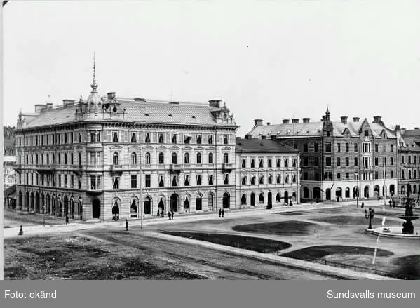 Fr v Kihlmanska huset, Storgatan 22, som inrymde Handelsbankens kontor 2 tr upp och Isaac Dehns våning 2 tr upp. T h Wessénska huset Storgatan 20, Fontänskulpturen, som invigdes 1886, finns på plats, men Vängåvans park är ännu inte anlagd.