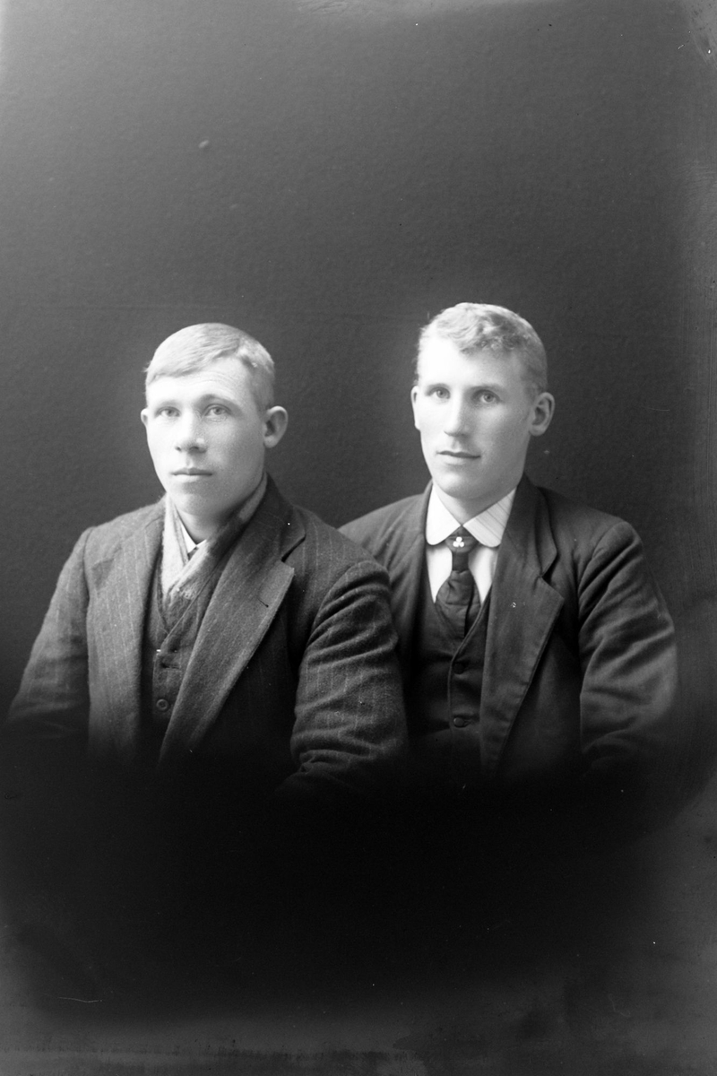 Studioportrett av to menn i halvfigur.