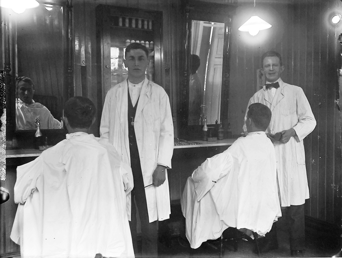 Portrett. 4 menn i en frisørsalong.Ukjent fotosted. Muligens Lofoten eller Meløy.  Interiør