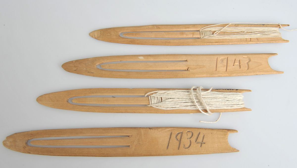 4 garnnåler av tørket bjørk, innskåret 1934 (2stykk) og 1943 (to stykk), merket NSM.014195 A-B-C-D. 2 nåler uten tråd, en med påmontert hampetråd (14195 C) og en med bommulstråd (NSM.14195D.)