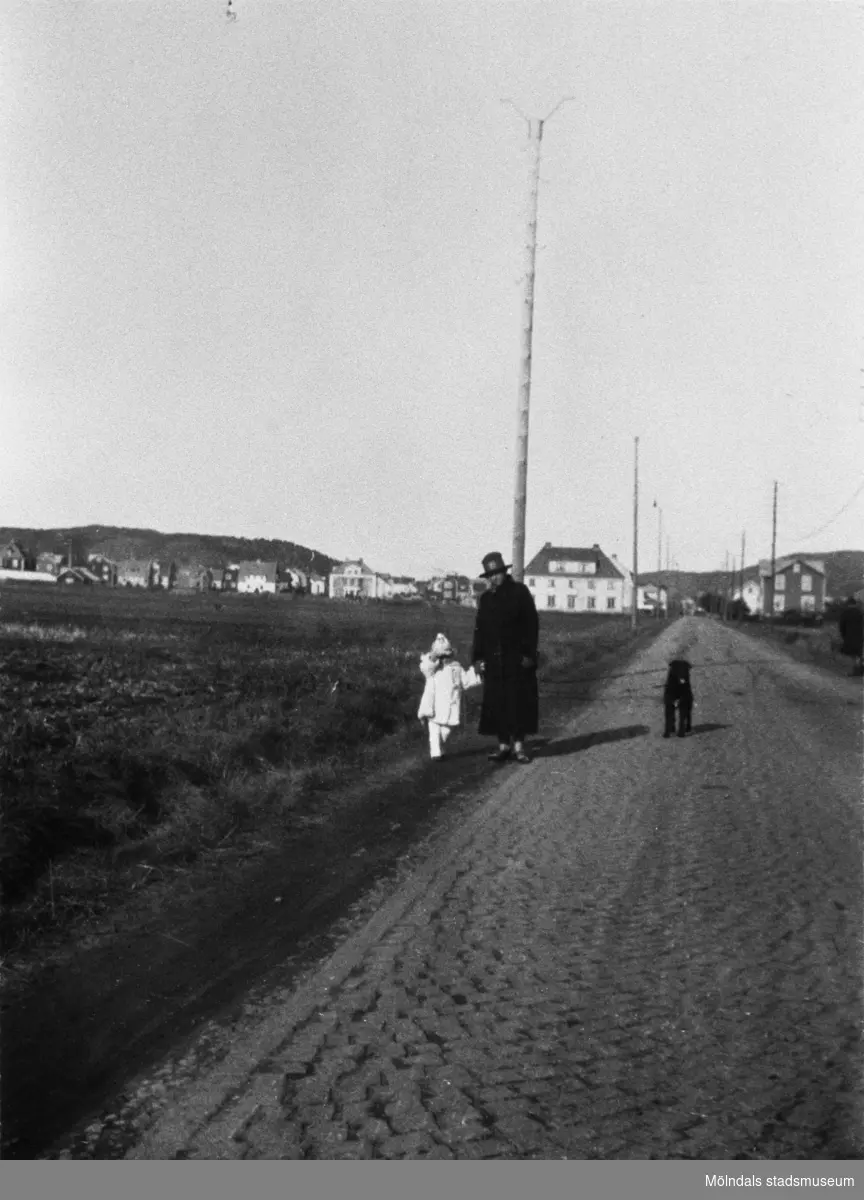 Margit Hellström och ett barn promenerar längs Kungsbackavägen (idag: Gamla Kungsbackavägen), okänt årtal.