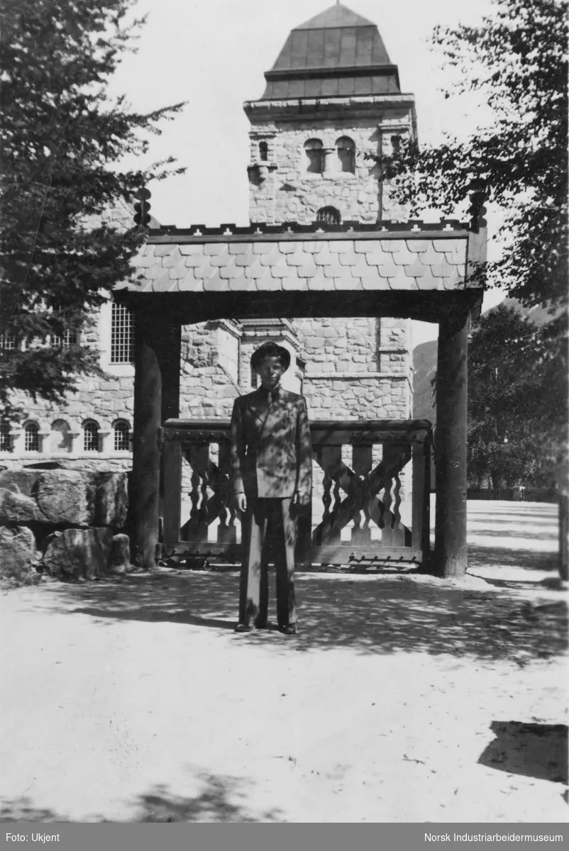 Mann foran Rjukan Kirke med portal ved inngangen til parken.