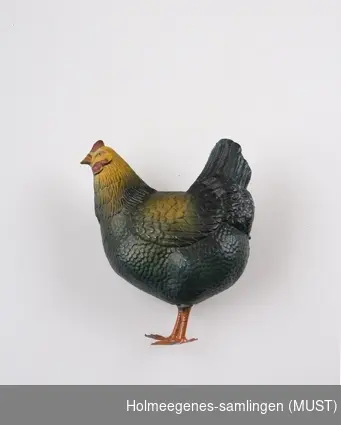 Lekedyr utformet som en høne, laget av celluloid med føtter av malt blikk.