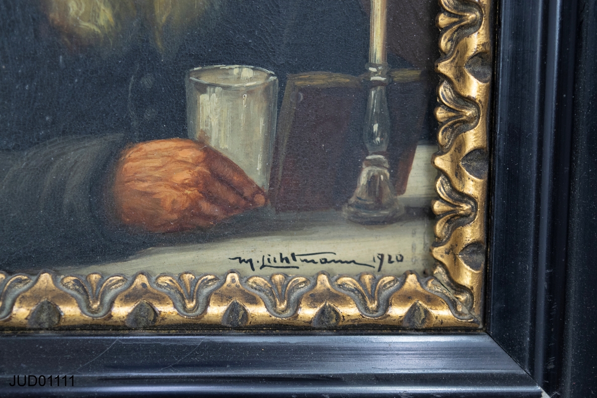 Inramad målning av man i skägg, sittande vid bord med bok, glas och ett tänt ljus.