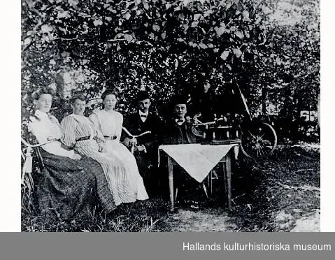 "Där Monark började. Birger Svensson med anställda. Fr v Fröken Skulander (fr Västergötland), Alida Skulander (senare gift med Birger Svensson), okänd dam, Carl Bartoldsson (fr Rolfstorp), Birger Svensson (fr Gödestad) samt en skjutspojke."