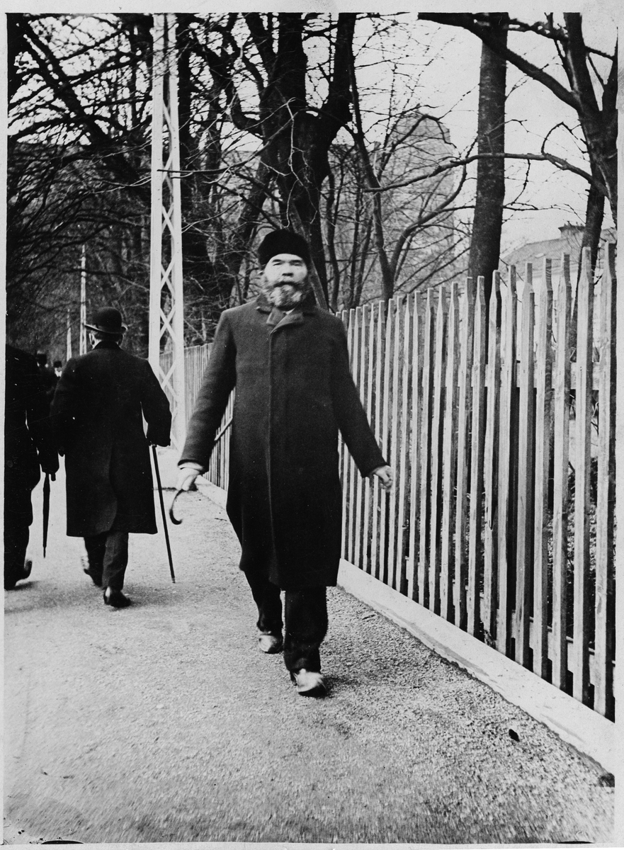 Uppsalaoriginalet och överliggaren Herman Baumbach promenerar på Munkgatan, kvarteret Fågelsången, Uppsala 1913
