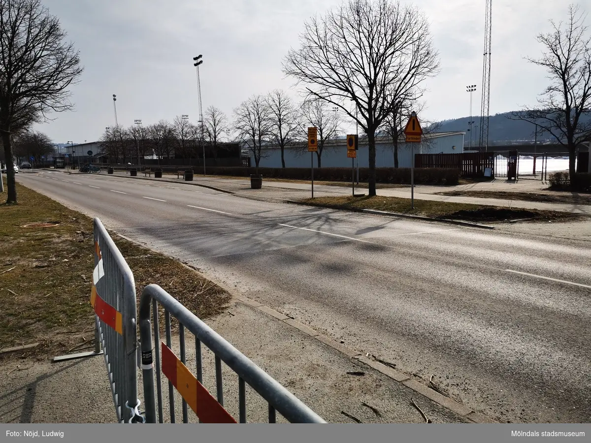 Vy mot sydost över Idrottsvägen mot Åby isstadion/Åby bandybana vilken har adress Idrottsvägen 5 i Åby, Mölndal. Fastighetsbeteckning är Hälsan 2. Fotografi taget den 15 mars 2022. Byggnadsdokumentation inför rivning.