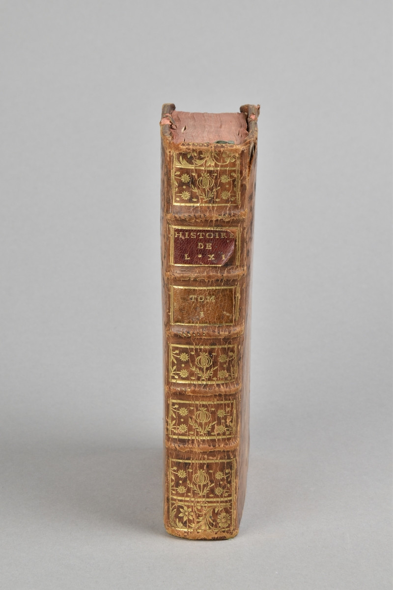 Bok, helfranskt band, "HISTORIE DE LOUIS XI.", del 1. Skinnband, guldpräglad rygg med fem upphöjda bind, fält med titel och volymnummer . Pärmarnas insidor klädda med marmorerat papper. Rött snitt. 