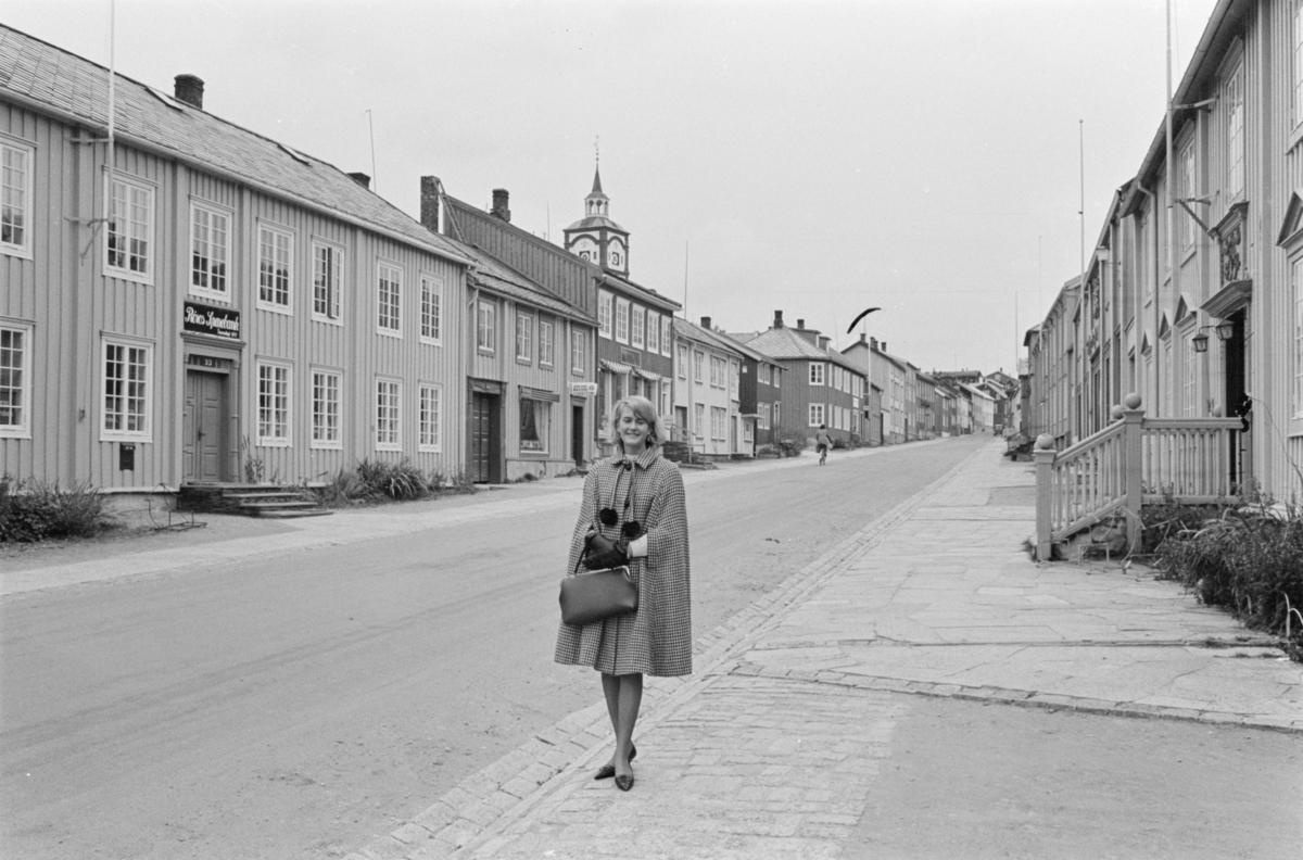 Portrett av en kvinne stående i en gate på Røros.