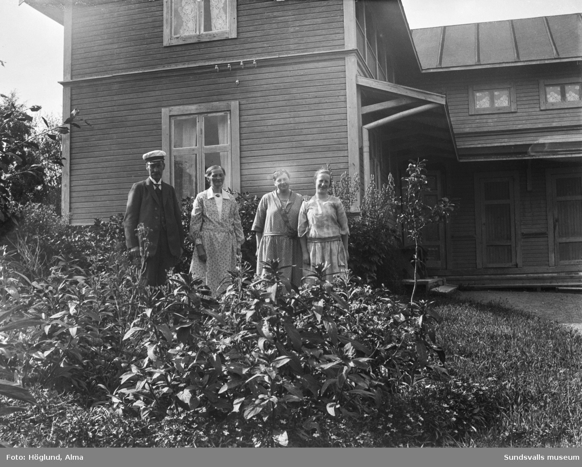 Två bilder av Erik Gustaf, Eva och Göta Bäckström, samt en oidentifierad kvinna, vid hemmet på Hammarn i Fanbyn. På första bilden syns bostadshuset bakom dem och på den andra står dom framför gårdshuset.