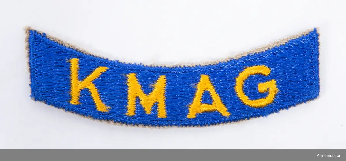 Grupp C I.
Emblem med texten "KMAG".
Textbandet under "Klockan".
