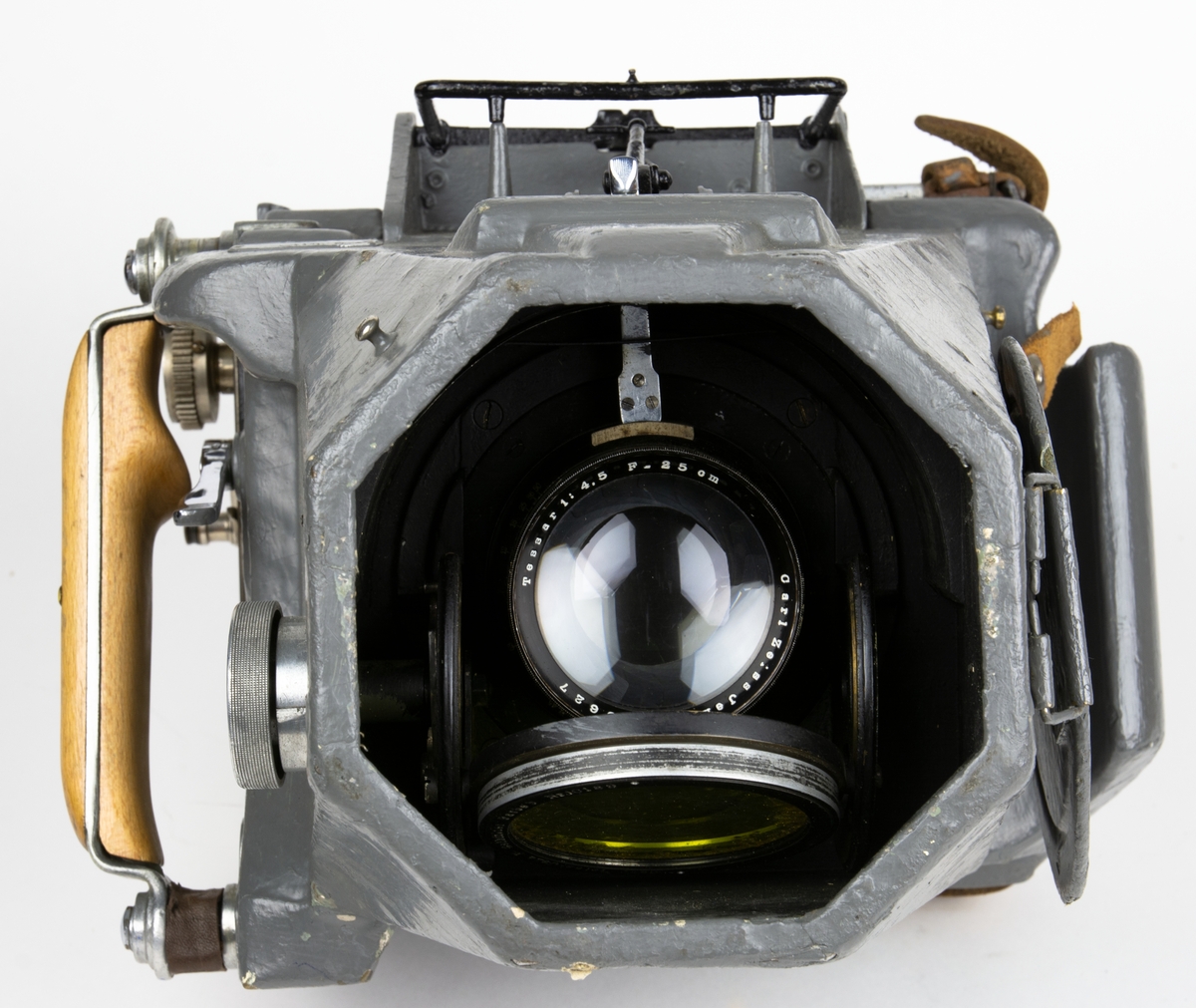 Handkamera, flygkamera av typ HK 1A. 
Bildformat: 13x18 cm. Objektiv: Tessar 1:4,5. F=25,11 cm. Carl Zeiss Jena nr.303627
Utrustad med fällbart gulfilter och objektivskydd. Kassett saknas.

Kamerakroppen är tillverkad i trämaterial. Slutarmekanismen och kassettenhet är lätt demonterbara medan objektivet är av fast typ. Sökaren utgöres av en nedfällbar ramsökare med pelarkorn. Kameran har ett objektivskydd med gångjärn och fäststropp.
Kameran är ytbehandlad med lackfärg i armegrå nyans. 

Till kameran hör förvaringslåda.