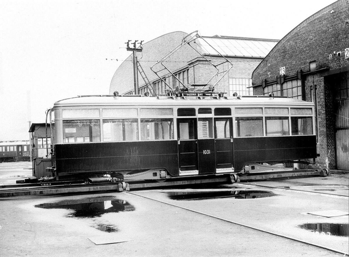 Fabrikkfoto av Ekebergbanen, nr. 1031, type HaWa. Vognen er toakslet med original-understell. Traversen på fabrikken.
