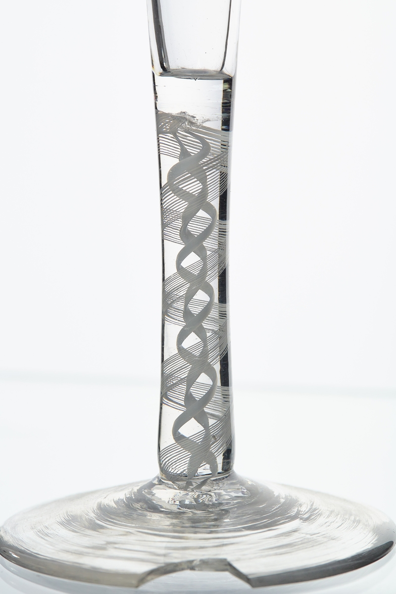 Glass med hvite spiraler i stetten.
