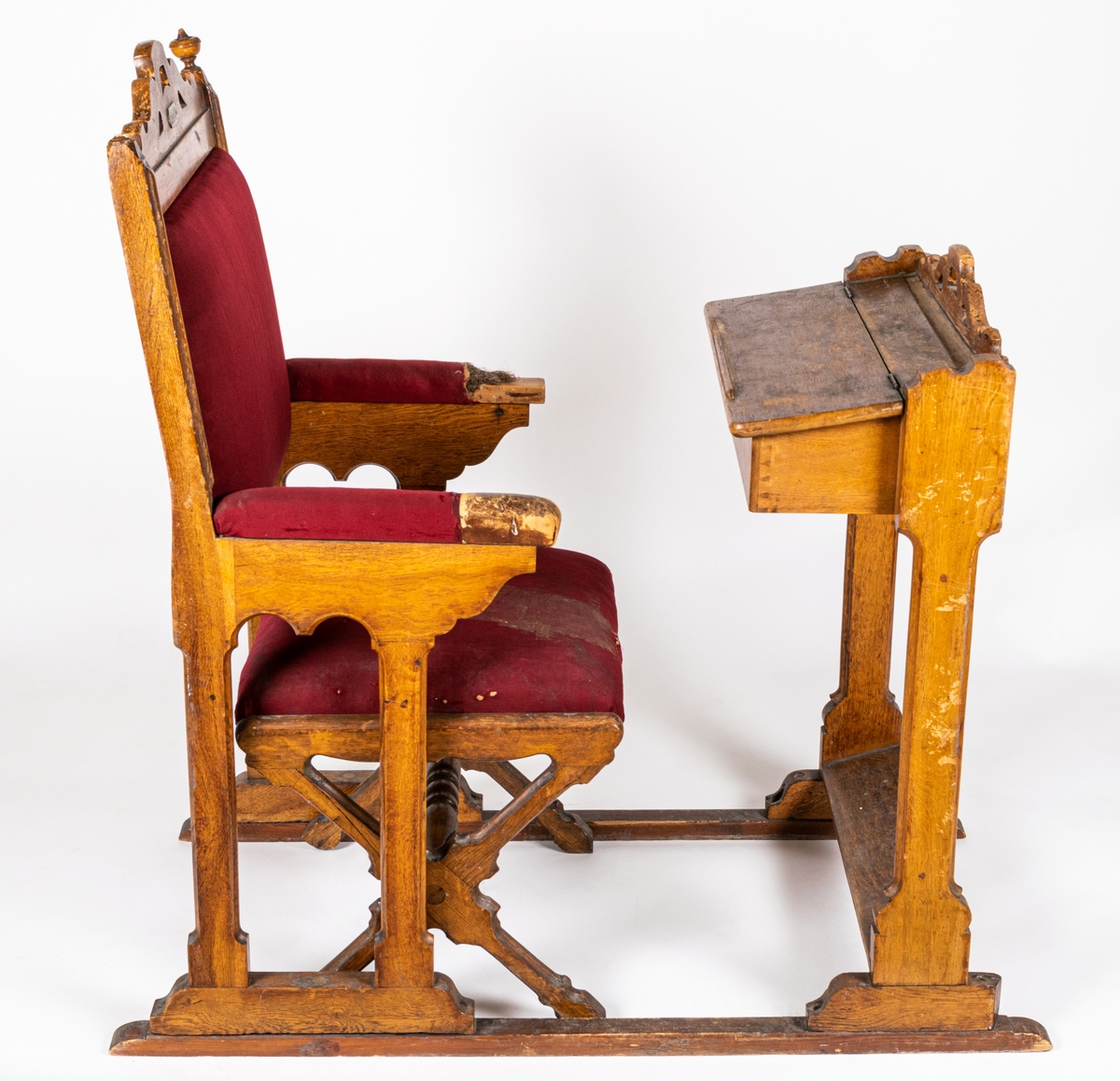 Riksdagsstol bestående av pulpet med tillhörande stol. Röd klädsel.