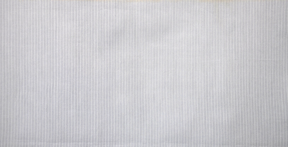 Bomullstyg, 1948.
Skjorttyg på 80 cm bredd, poplin. Tryckt enkulört smalrandigt, av otvinnat garn.
Sanforiserat.