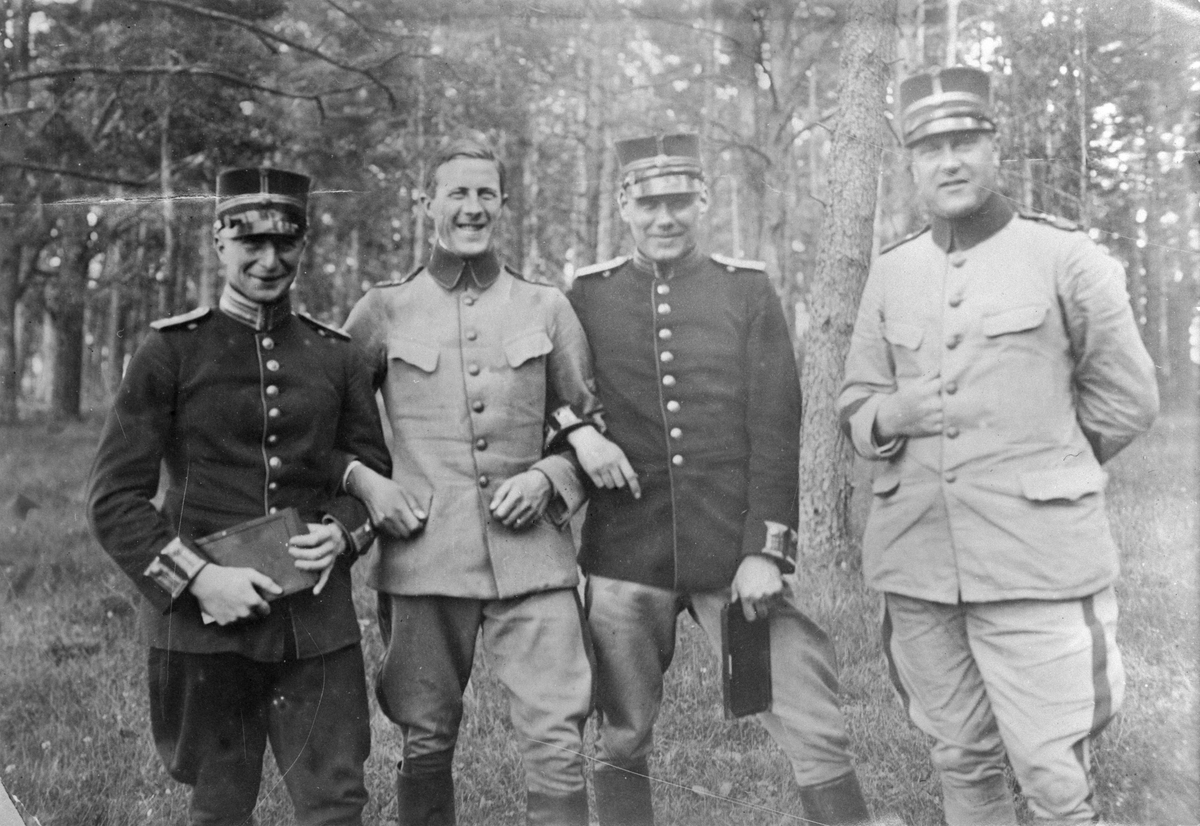 Gruppfoto av fyra militärer ståendes i skogsparti. Andra mannen från vänster är militära flygaren Georg Gärdin, tredje fr.v. Lindén. Cirka 1920-tal.
