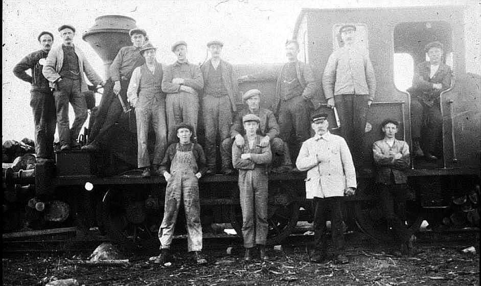 Arbeidere ved jernbanen på Borregaard fotografert ved et lokomotiv