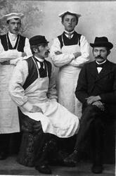 Studioportrett av bakermester Martin Jakobsen med tre bakers