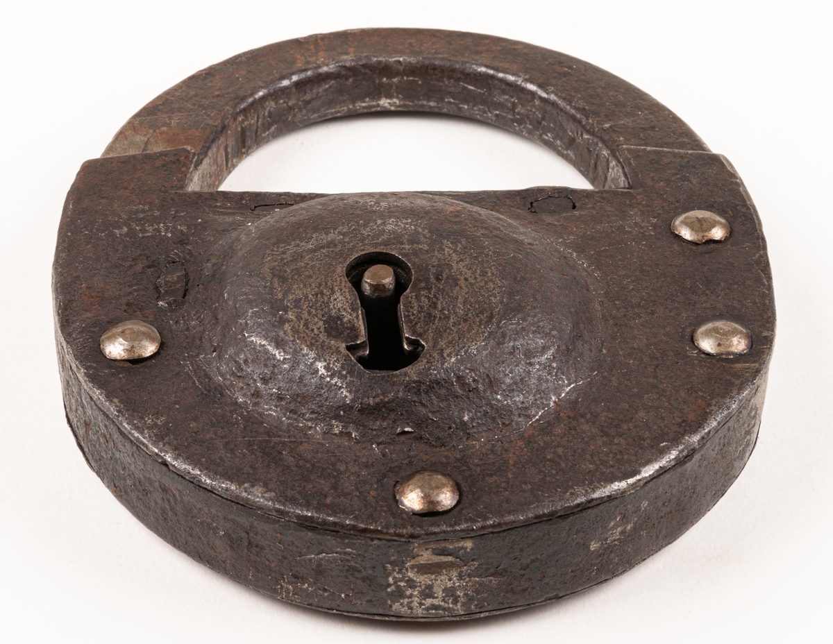 Hänglås, av järn, rundat. Med nyckel. Från brännvinskällare vid Strömsbro kronobränneri. Källarens portar märkta 1734.