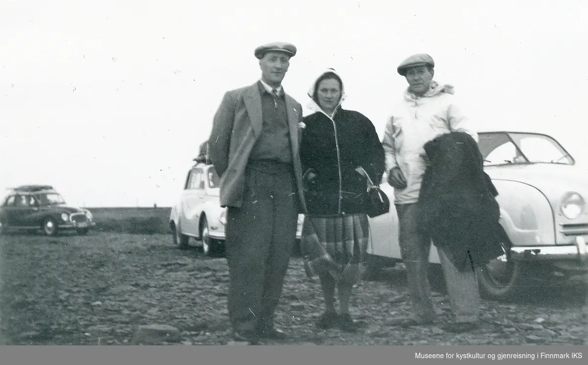 Albin Hartvigsen (t.h.) med vennepar på Nordkapp. I bakgrunnen flere personbiler. 1956.