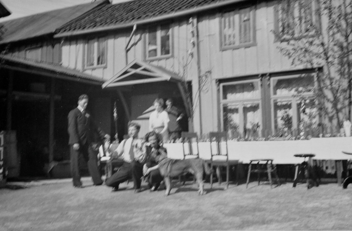 Hertze eller Solly Caplan med familiens hund Rix og andre venner eller familiemedlemmer i familien Caplans bygård i 17.mai 1940