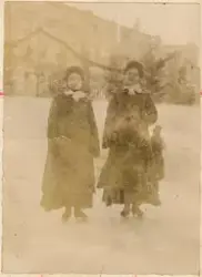 To unge kvinner står på skøyter.