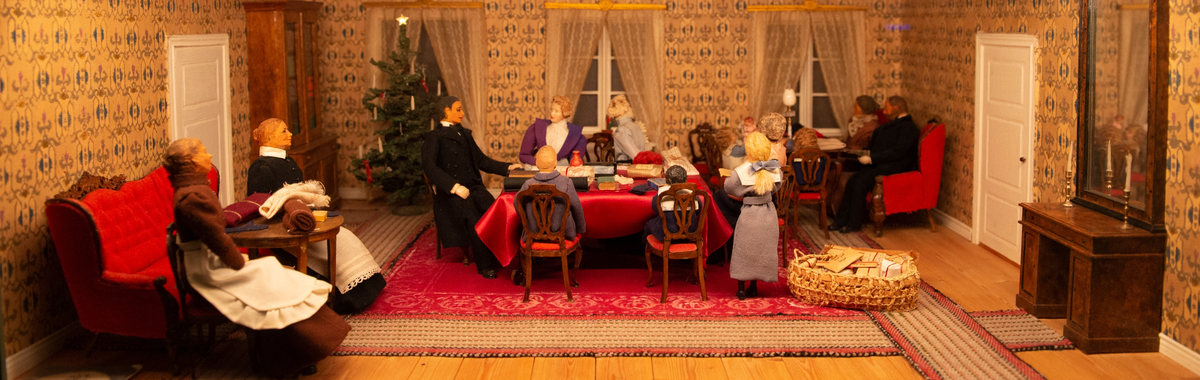Tittskåp med utomhus- och inomhusscener med skalenliga detaljer och dockor som återberättar Berith Bergströms och henns syskons jultraditioner och-firande vid Bosjöhyttans herrgård i början av 1900-talet.