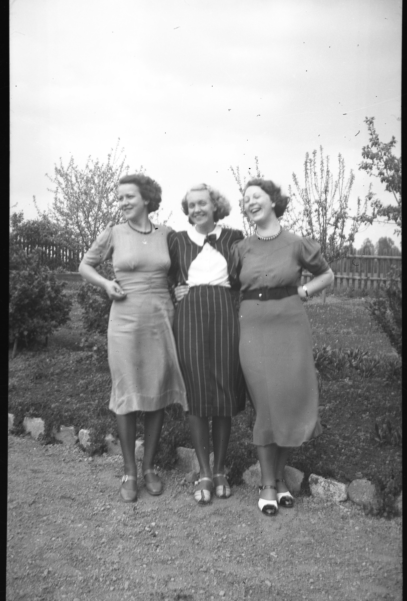 Tre kvinnor poserar framför kameran. Ingrid Sundling till höger.