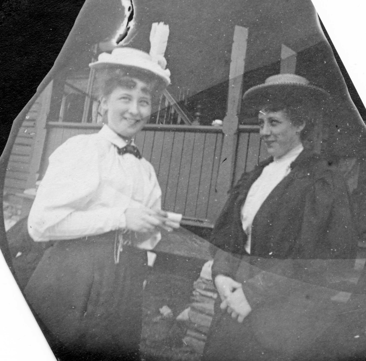 Frk. Anna Holm og frk. Birgit Holm, dr. Holms døtre, foran veranda til tømmerhus. Muligens Golaa, Sør-Fron.