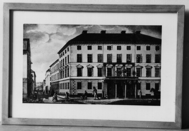 Offsettryck av posthuset Lilla Nygatan, Stockholm efter litografi av Ferdinand Tollin (1807 - 1860). Offsettrycket gjordes på Postmuseums affisch till 60 års jubileet 1966. I beigebetsad ram med glas.