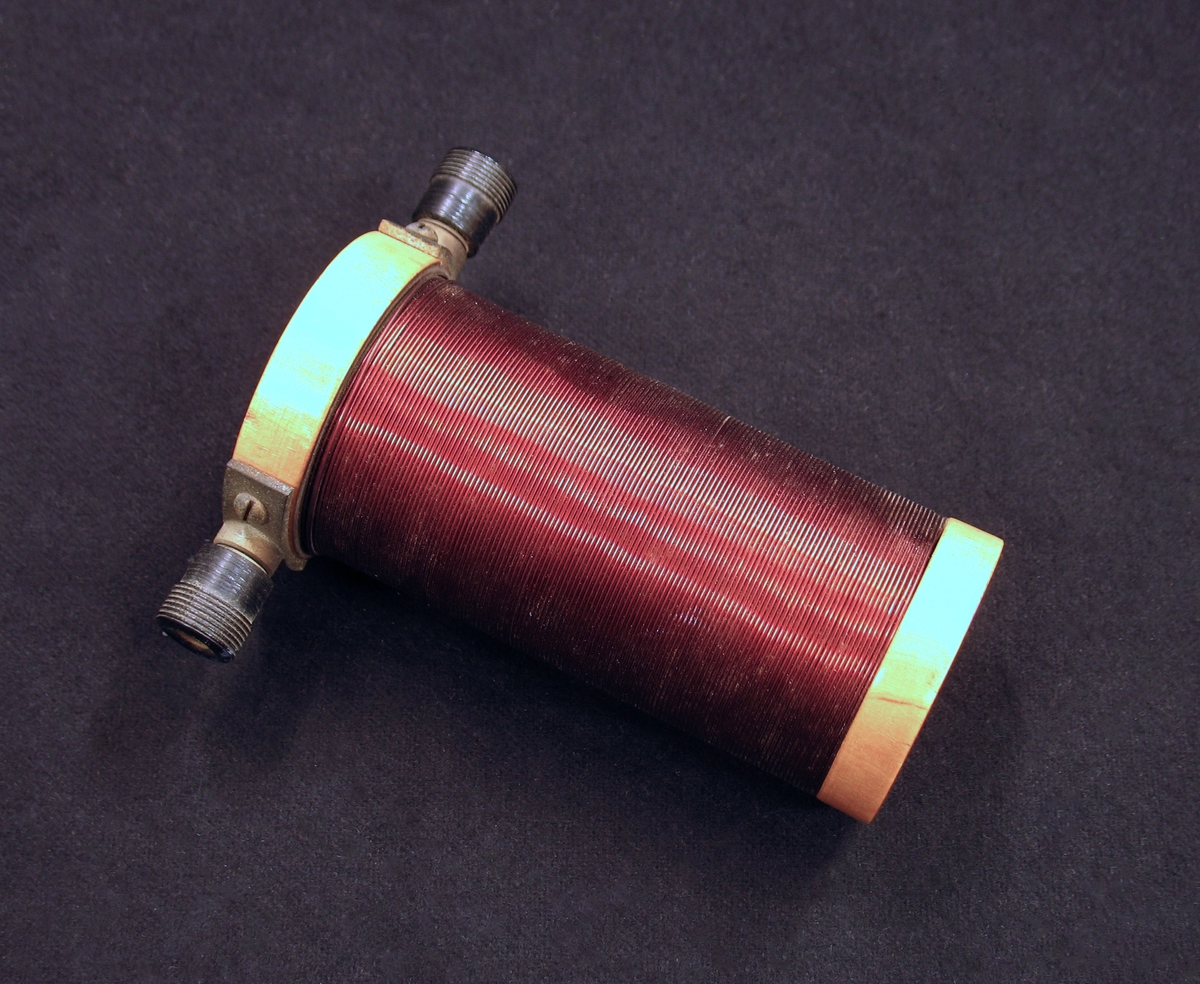 En cylinderformad elektromagnet i trä och metall med hål rakt igenom.
 Har troligen använts i fysikundervisning. 

Undervisningsmaterial från skolor i Vänersborg.
