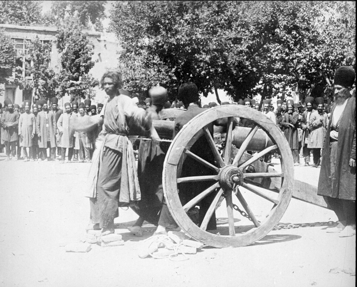 "Avrättningssätt i Chiraz för blott 3 år sedan (1911)." En man fastbunden med ryggen mot en kanons mynning.