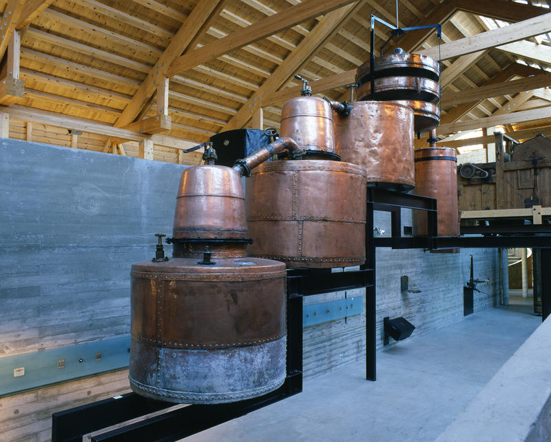 Farm destilleri with large copper pots.