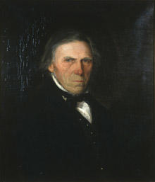 Portrett av Ole Illerød. Mørk drakt, vest og halsbind. Hvit skjorte.