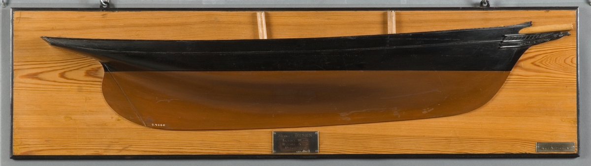 Halvmodell av lustkuttern "ÖRNEN" i block av trä, styrbords sida. Två master, bogspröt samt galjonsbild i form av örn. Skrov svart och brunmålat, monterat på ljus träplatta med svart kant. Två silverplåtar med graverad text: mitten, "Skonert Örnen, L.i.w.l. 21,4 m, B.i.w.l. 5,0 m, Piteå 1877." t.h. "Konstruktör Kaj Agersskov."