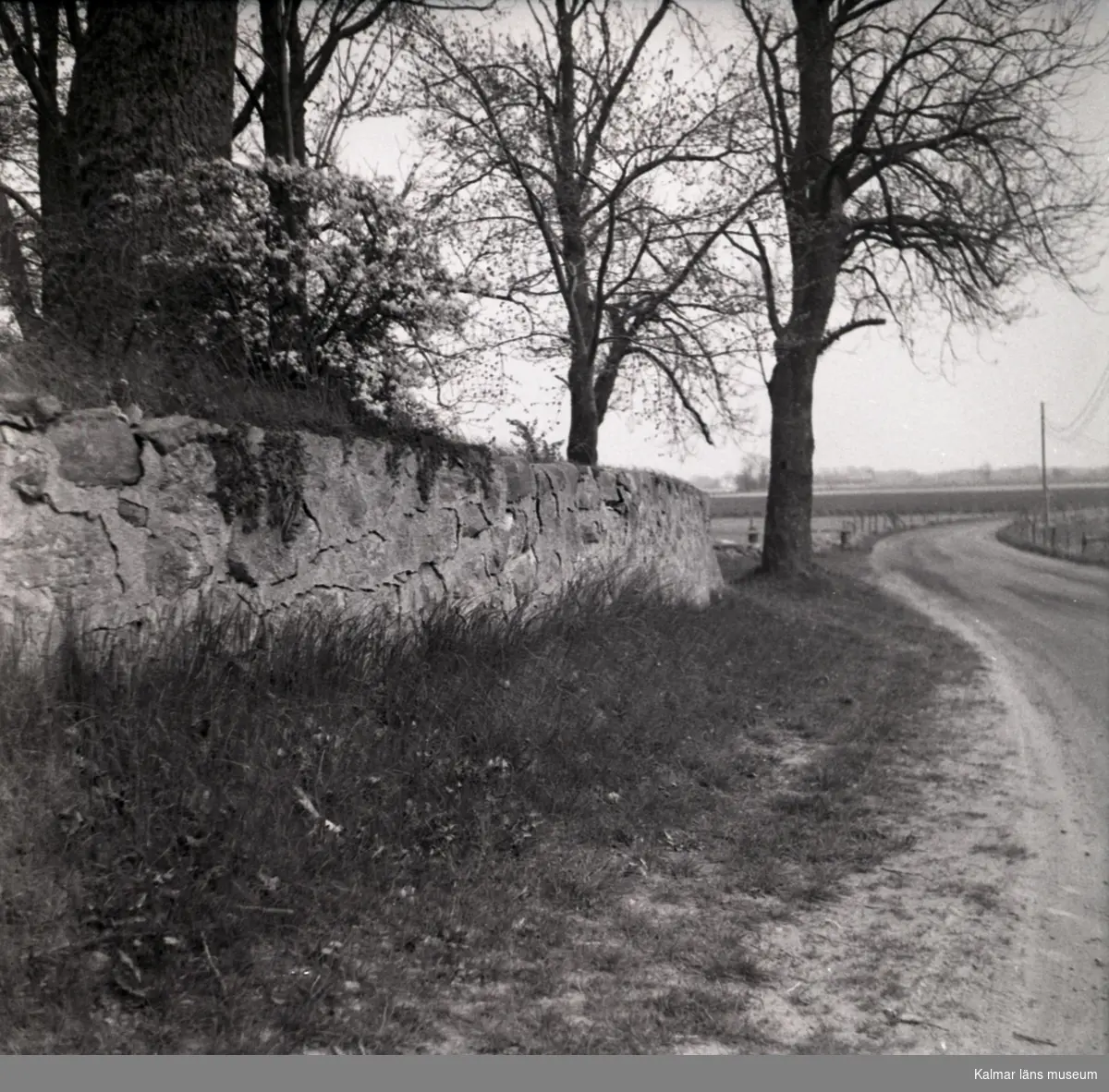 Vy med vägen och kyrkans stenmur i Voxtorp.