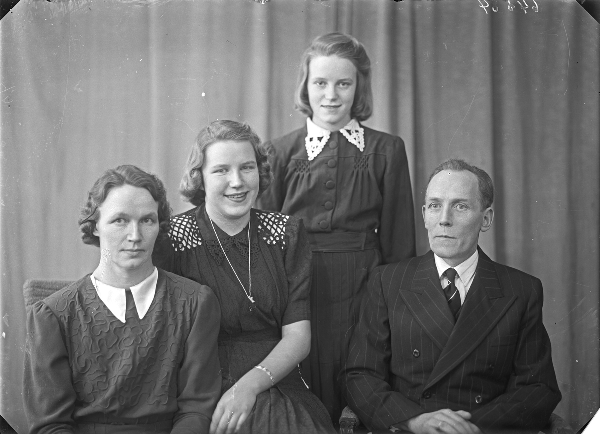 Portrett. Gruppebilde. Familiegruppe på fire. Kvinne, mann og to piker.  Bestilt av Ole Dale Breidablikgt. 85.