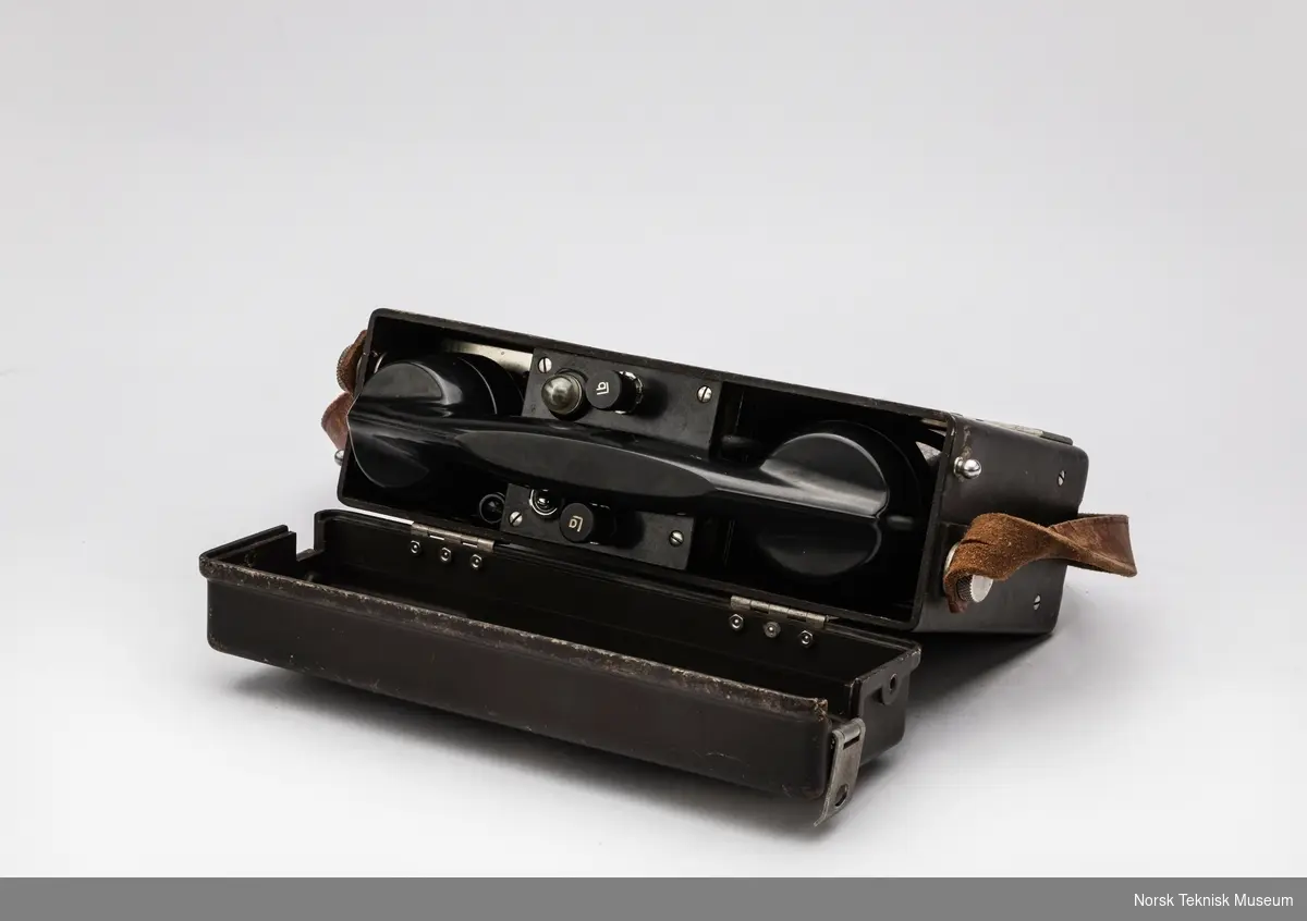 Bakelitt boks med lokk, bærereim i lær, modifisert med NRK-kontakt i bakpanel og XLR-kontakter i front, en for linje og en for hodetelefoner