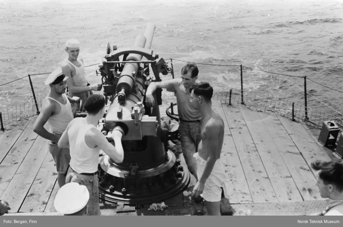 En gruppe personer og en kanon, på skipsdekk