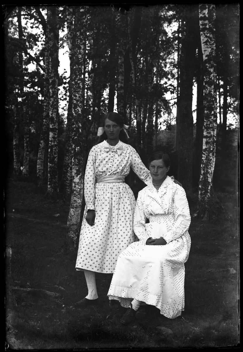 Två kvinnor i prickiga klänningar
