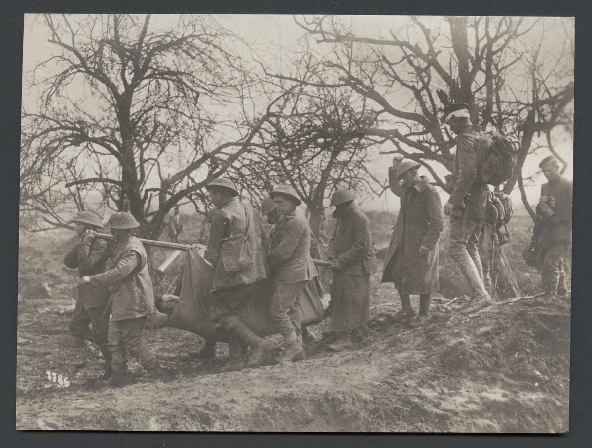 Bilden visar engelska soldater som bär en skadad på en bår

Originaltext: "Tillfångatagna engelsmän föra en sårad kamrat till en tysk förbandsstation."
