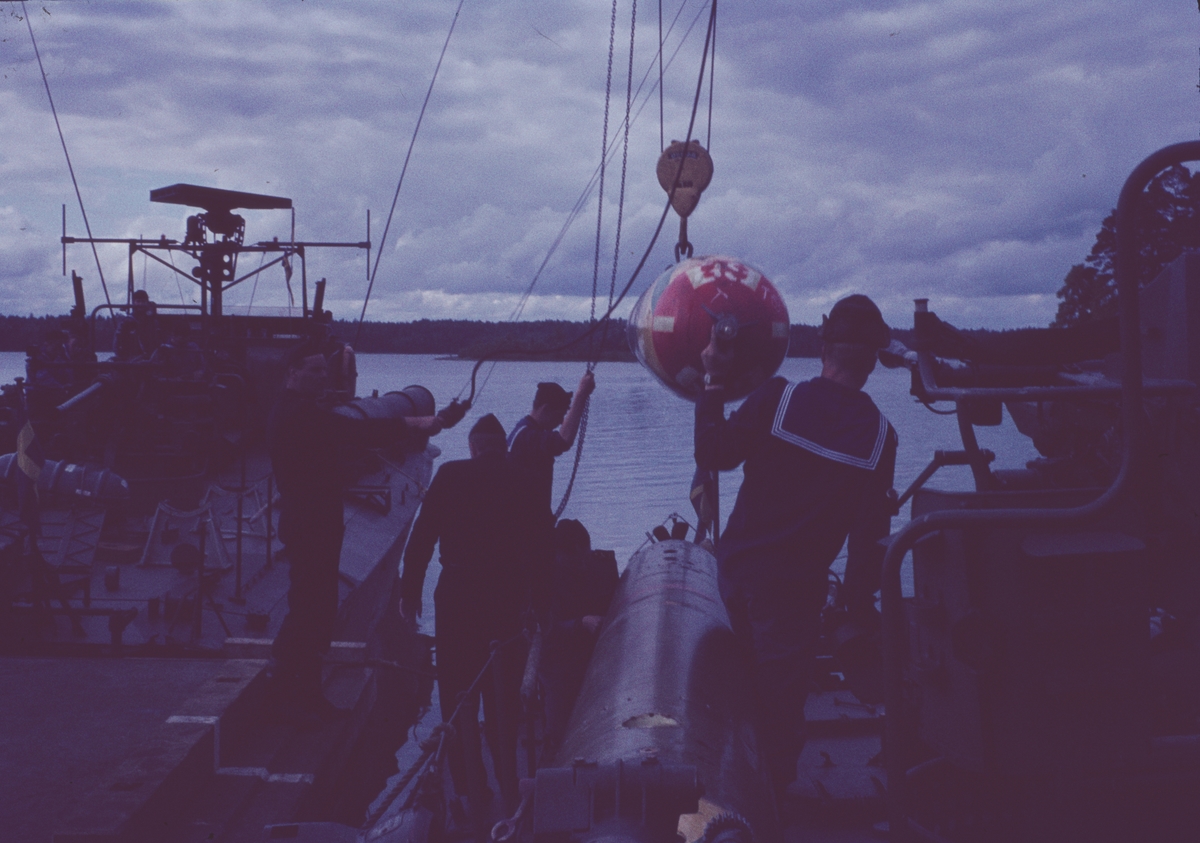 Bilden visar hur torpeder lastas ombord på en motortorpedbåt.