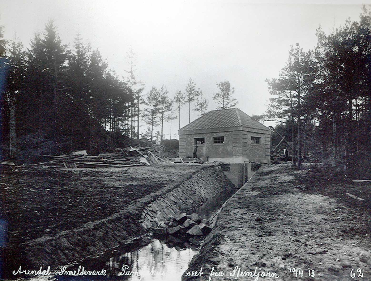 "10/04-1913" Nitriden. Smelteverket. Pumpehus ved Stemtjern. Vannkildene til bedriftene. Steinsatt kanal ut mot Stemtjern i forgrunnen.