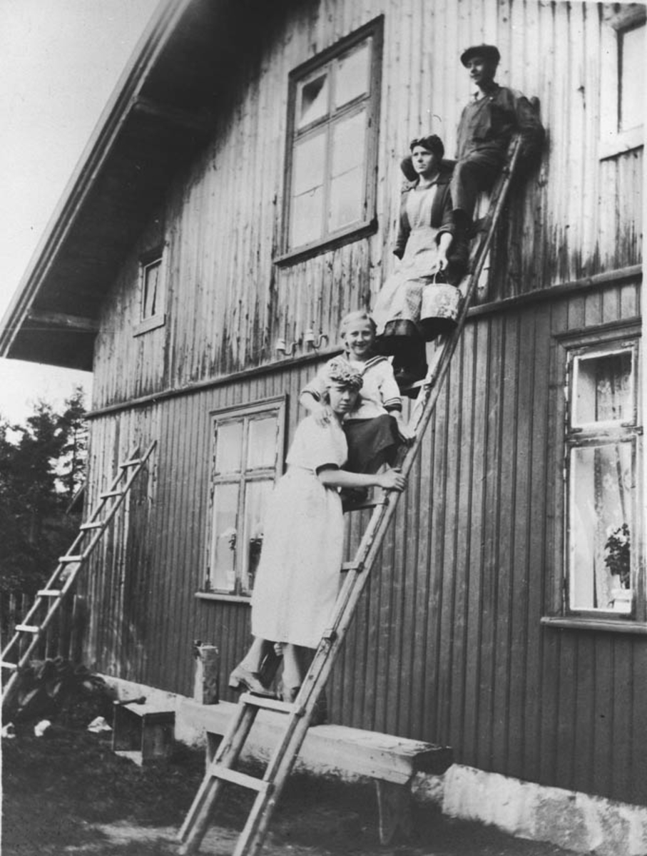 Personer på stige foran Høibraaten-huset