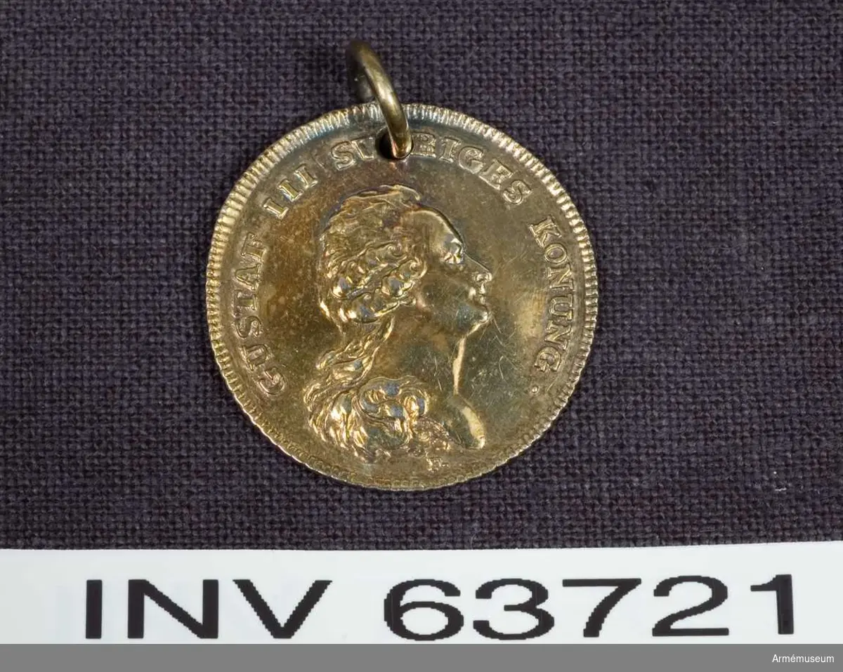 Åtsidan: Text samt Bröstbild av Gustav III i bröstbild åt höger, bart huvud med långt utslaget och framkastat hår.
Frånsidan: text på tre rader inom en lagerkrans. Medaljens kant strierad på båda sidor, randen räfflad.