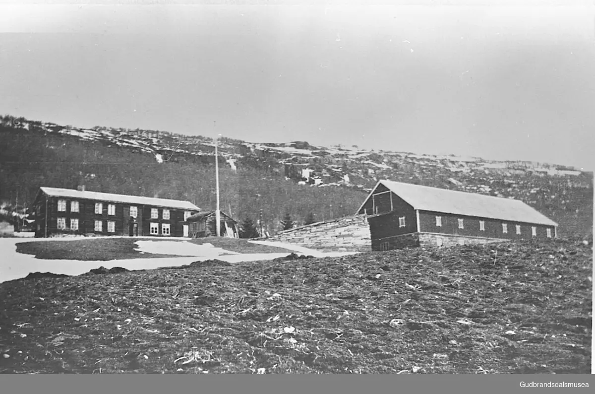 Gårdstun og jorde, fjell i bakgrunnen, det er vår i Brandli, etter 1928.