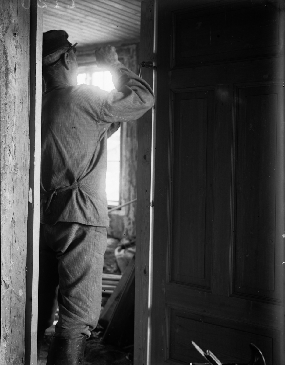 "Byggmästar Adolf Hedin passar in dörrarna i villan", Sävasta, Altuna socken, Uppland 1918